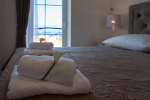 a pile of towels sitting on top of a bed at SOBE "GALEB" in Vrbnik