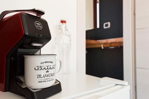 a coffee maker and a coffee cup on a counter at Is Seddas B&B in Bari Sardo