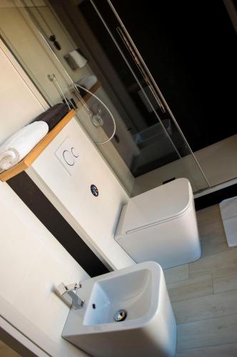 a bathroom with a sink and a toilet at Is Seddas B&B in Bari Sardo
