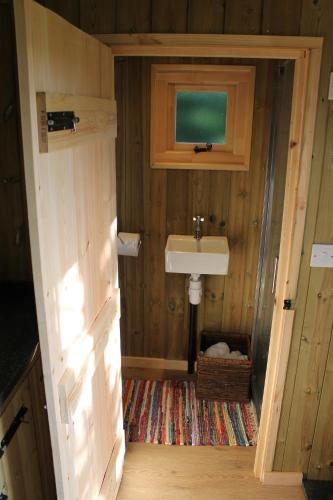 a small bathroom with a sink and a sink at Shepherd's Hut - The Quirky Quarry in Middleton in Teesdale