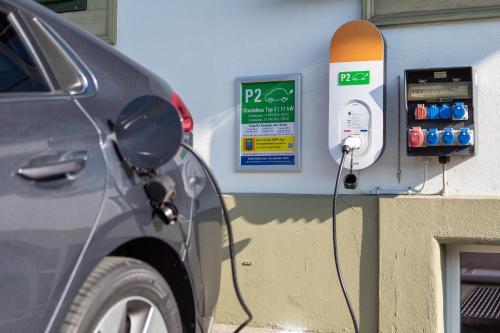 a car is hooked up to a gas pump at Backpackers Villa Sonnenhof - Hostel Interlaken in Interlaken