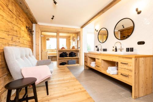 a bathroom with a sink and a mirror at Superior Chalet Brandleit in Hart im Zillertal