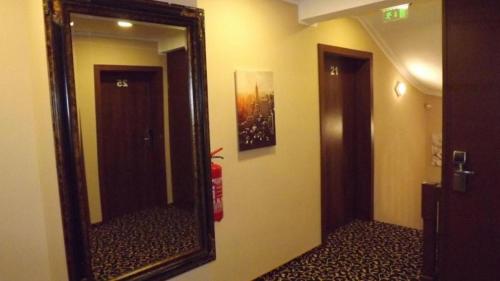 a mirror on a wall in a room with a hallway at Hotel zum Weissen Ochsen in Aalen