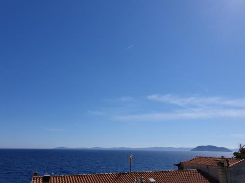 a view of the ocean with buildings and roofs at Seaside Villa in Neos Marmaras