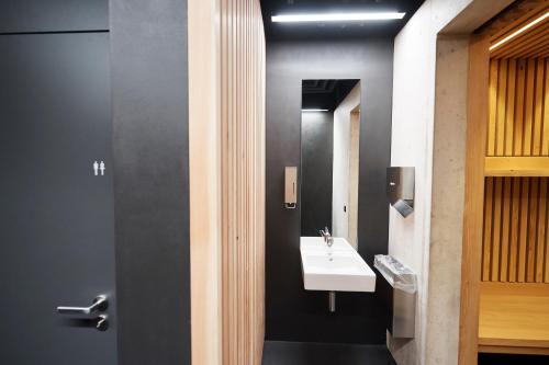 a bathroom with a sink and a mirror at CAMPUS SURSEE Seminarzentrum in Sursee