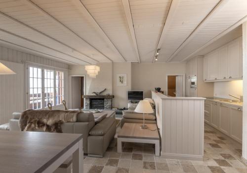 a living room with a couch and a table at Panorama 59 in Arolla