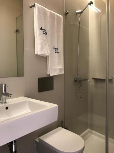 a bathroom with a sink and a toilet and a shower at Change The World Hostels - Coimbra - Almedina in Coimbra