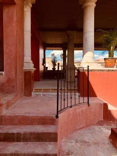 an entrance to a building with stairs and pillars at Casa Eugenia Hotel in Morelia