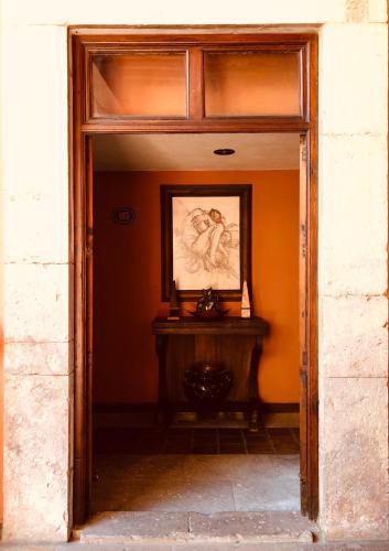 an entrance to a room with a painting on the wall at Casa Eugenia Hotel in Morelia
