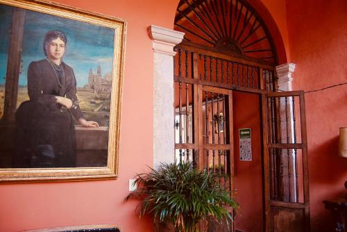 a painting of a man on a wall next to a door at Casa Eugenia Hotel in Morelia