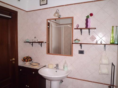 a bathroom with a sink and a mirror at Casetta dei "Prati" in Vaglio di Basilicata