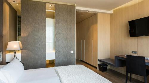 Ein Bett oder Betten in einem Zimmer der Unterkunft Hotel MiM Sitges & Spa