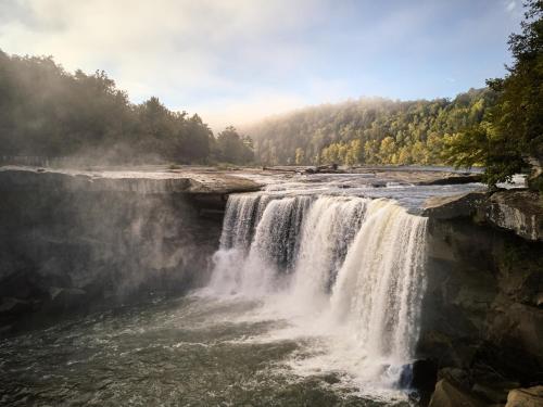a waterfall in the middle of a river at Cumberland Falls State Resort Park in Honeybee