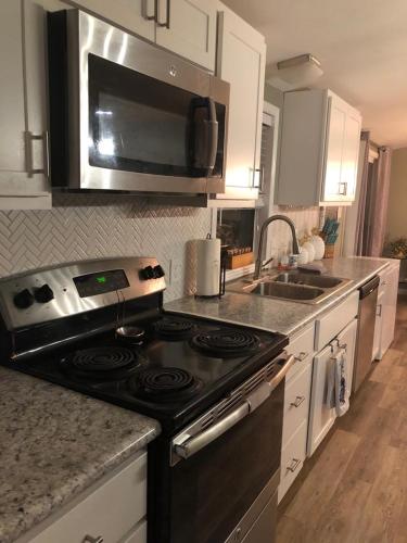 a kitchen with a black stove and a sink at Sedona Red Rock Garden of Paradise Pets friendly and Hot tub in Sedona