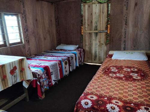 เตียงในห้องที่ Chintapu Homestay In Ilam, Eastern Nepal