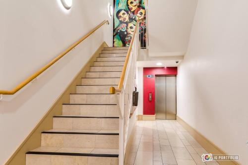 a staircase in a building with a mural on the wall at Tyler’s Rest in Belfast