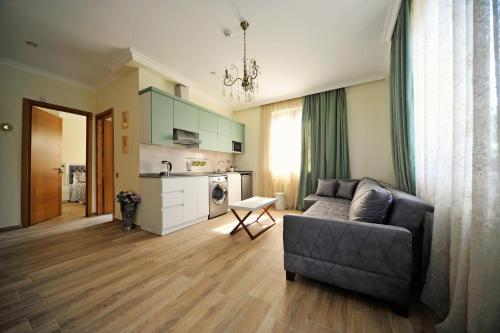 a living room with a couch and a kitchen at Guest House Botanical Paradise in Mtsvane Kontskhi