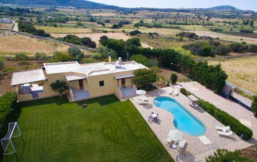 an aerial view of a house with a swimming pool at Naxos Cottage in Káto Sangríon