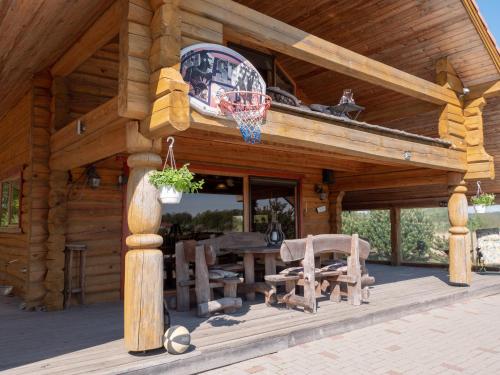 a log cabin with a basketball hoop on the roof at Privatus rąstinis namas su pirtimi in Dėckiai