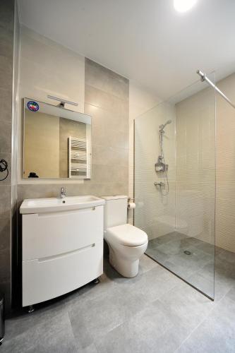 a bathroom with a toilet and a sink and a shower at Guest House Botanical Paradise in Mtsvane Kontskhi