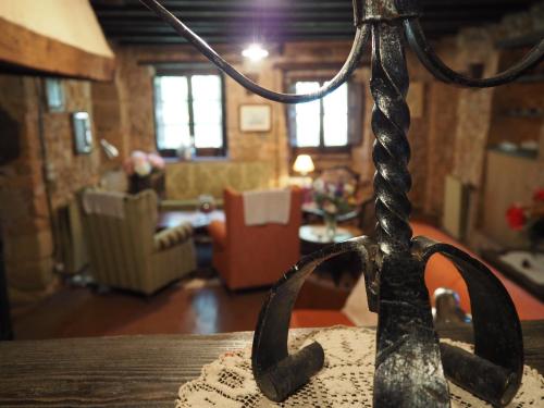 a room with a living room with a table with a rope at Mas Cal Sastre in Sant Hilari Sacalm