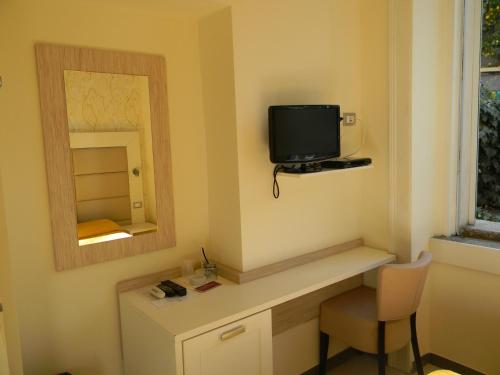 a room with a television and a desk at Villa Vittoria Tropea B&B in Tropea