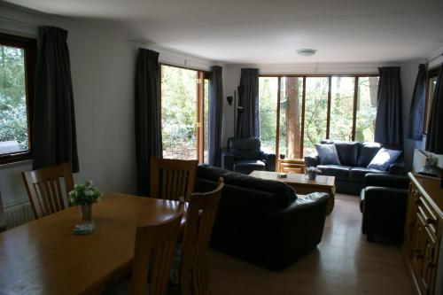 a living room with a couch and a table at t'Bakkersboschje nummer 8 in Putten