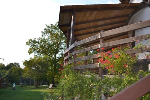 a wooden fence with flowers on it in a park at Inspire View - Boutique in Bran