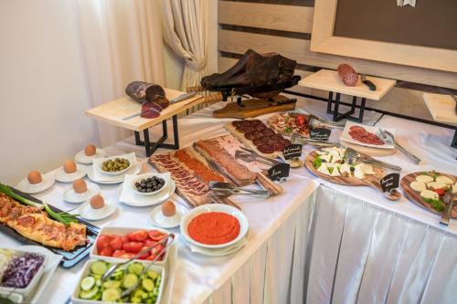 a buffet with many different types of food on a table at Hotel Soa in Žabljak