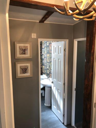 a hallway with a door leading to a bathroom at The Stags Lodge in Newton on the Moor