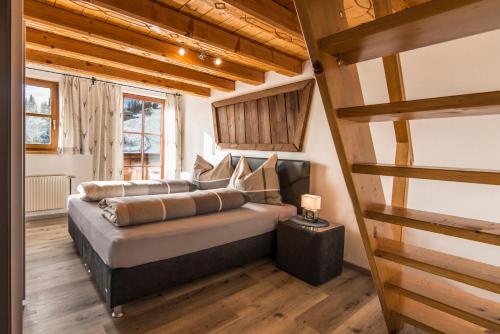 ein Schlafzimmer mit einem Bett in einem Zimmer mit Holzdecken in der Unterkunft Ahornhütte Gastein in Bad Gastein