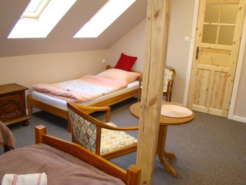 a bedroom with a bunk bed and a desk and a table at Pensjonat Dworek Baranówka in Goniadz
