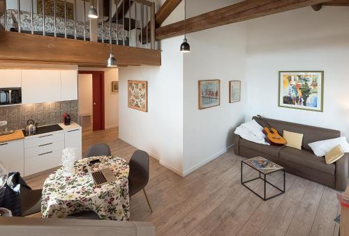 a living room with a couch and a table at Barchessa Rossetti in Concordia Sagittaria