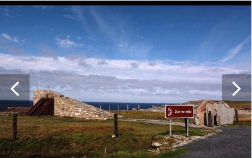 a sign on the side of a road near the ocean at The West House in Belmullet