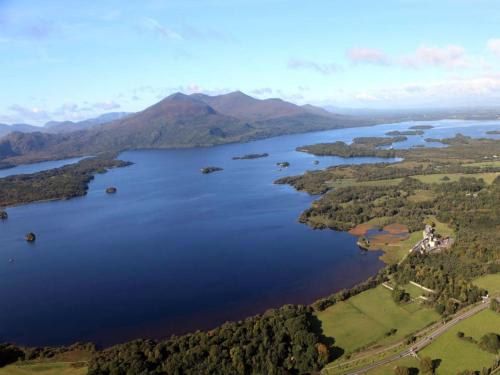 an aerial view of a lake in the mountains at Killarney Randles Hotel in Killarney