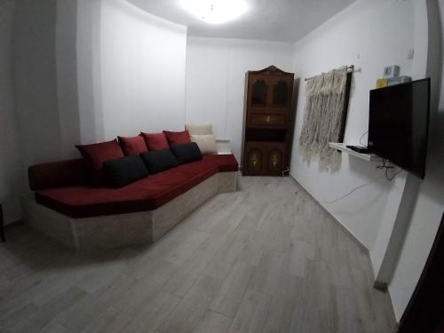 a living room with a couch and a television at kinneret love sounds in Migdal