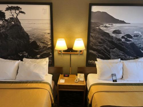 two beds in a hotel room with two lamps at Super 8 by Wyndham Fort Bragg in Fort Bragg