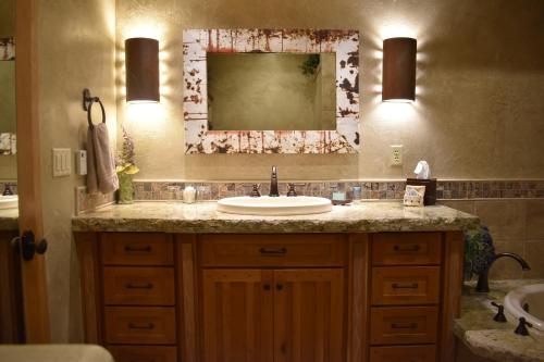 a bathroom with a sink and a mirror at Cougar Ridge Resort in Torrey