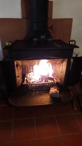 a fireplace with a fire in it at Borgo Vecchio in Carbognano