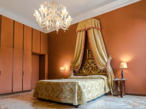 a bedroom with a bed with a canopy at Luxury balcony apartment in Venice