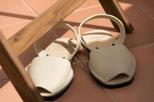 a pair of white shoes sitting on a floor at HOTEL ANHEL in Ferreries