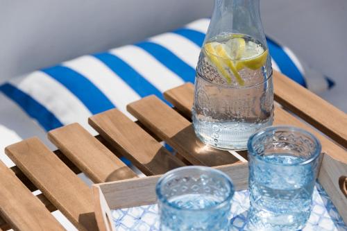 a bottle of water and two glasses on a tray at HOTEL ANHEL in Ferreries