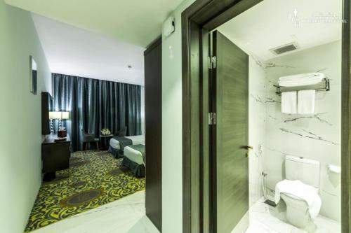 a hotel room with a door leading to a bedroom at LeChateau Boutique Hotel in Jeddah