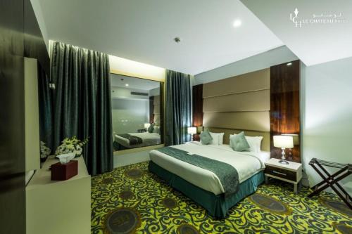 a hotel room with a bed and a large mirror at LeChateau Boutique Hotel in Jeddah