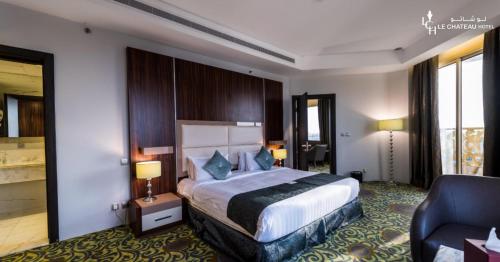 a hotel room with a bed and a chair at LeChateau Boutique Hotel in Jeddah
