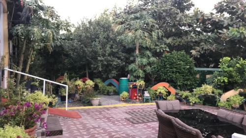 a garden with a playground in the background at Happiness Farm in Hatta