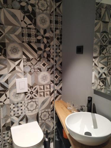a bathroom with a white toilet and a sink at B & W KRIŽ in Ajdovščina