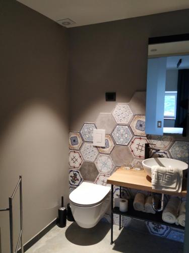 a bathroom with a toilet and a sink at B & W KRIŽ in Ajdovščina