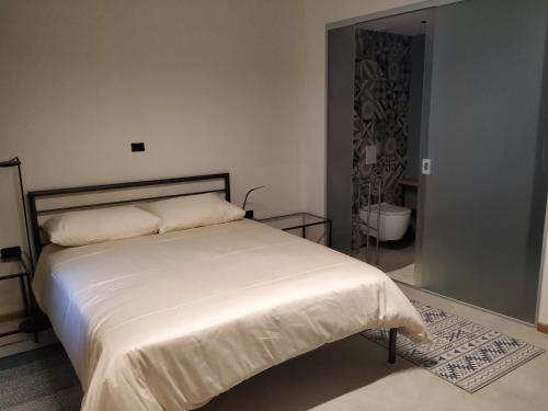 a bedroom with a large bed with white sheets at B & W KRIŽ in Ajdovščina