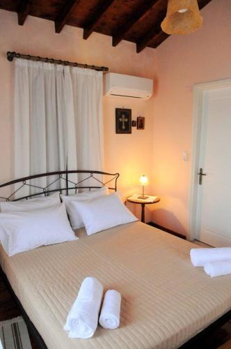 a bedroom with a bed with two towels on it at Melpomeni Villa in Mythimna